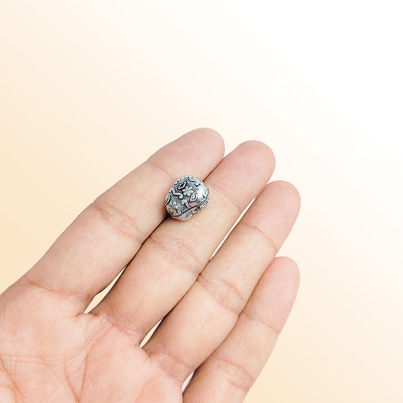 Silver tribal bead cap from India with textured artisan design, handcrafted using silver overlay over copper.