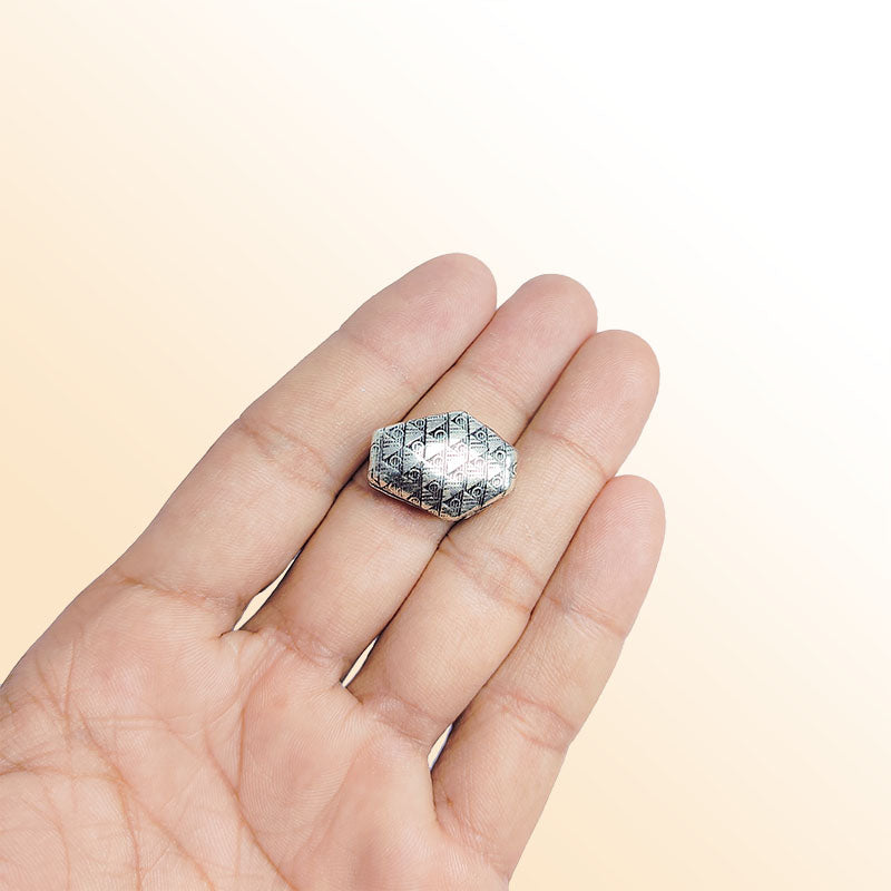 Silver faceted bead cap from India with geometric textured design, handcrafted using silver overlay over copper.