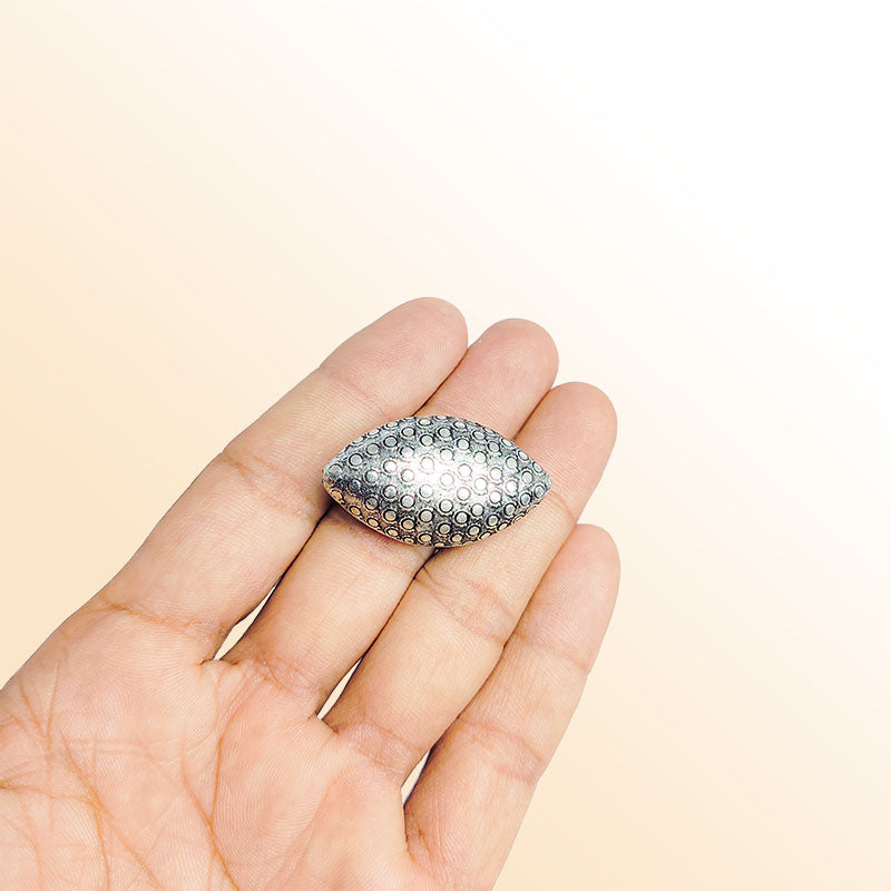 Silver oval bead cap from India with dotted textured design, handcrafted using silver overlay over copper.