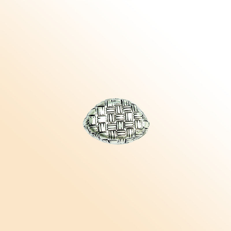 Silver oval bead cap from India with geometric textured design, handcrafted using silver overlay over copper.