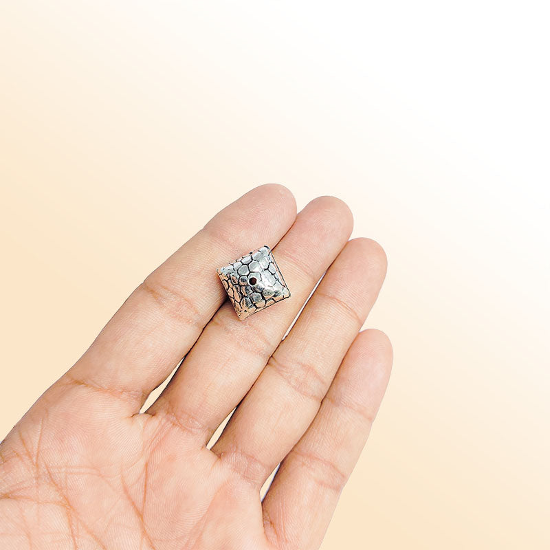 Silver square bead cap from India with pebble textured pattern, handcrafted using silver overlay over copper.