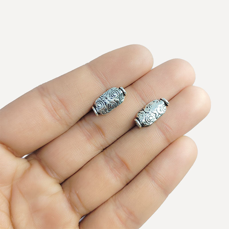 Elegant oval silver overlay over copper bead handcrafted in India with embossed floral detailing