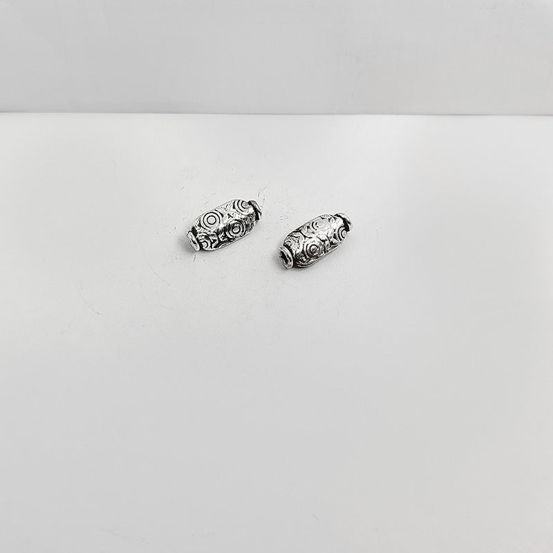 Elegant oval silver overlay over copper bead handcrafted in India with embossed floral detailing