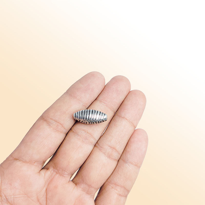 Ribbed elongated silver overlay over copper bead handcrafted in India with vertical engraved texture