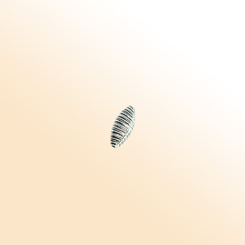 Ribbed elongated silver overlay over copper bead handcrafted in India with vertical engraved texture
