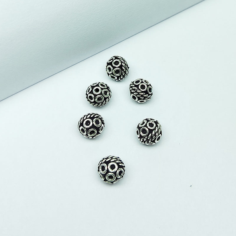 Ornate round silver overlay over copper bead handcrafted in India with rope style and circular design