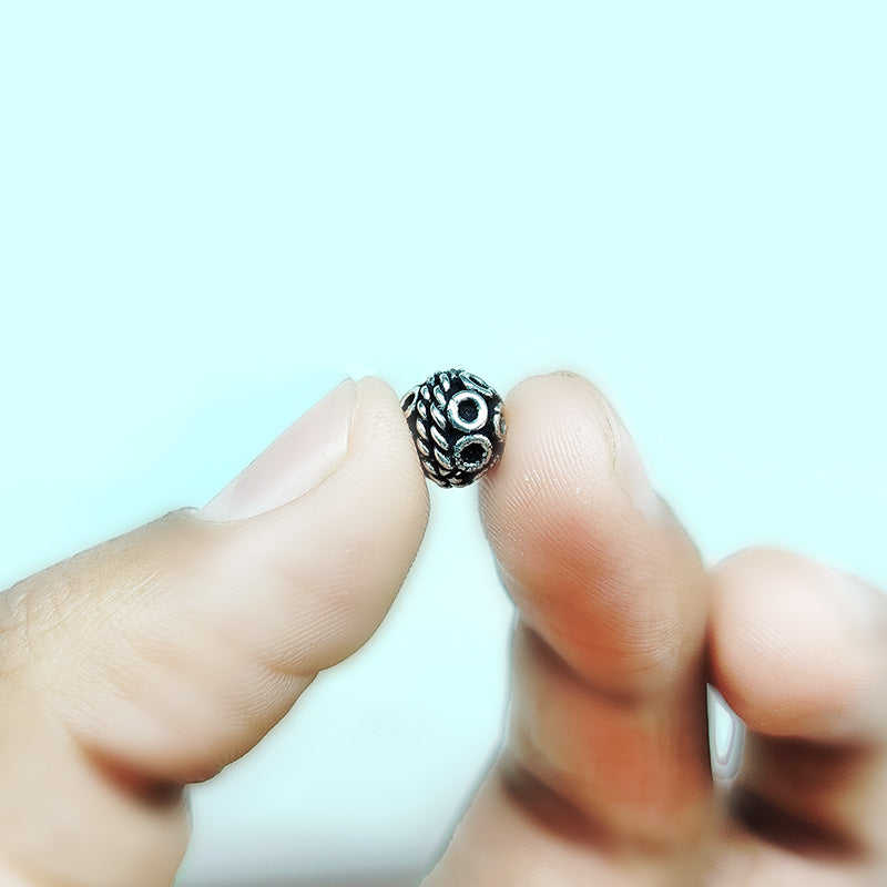 Ornate round silver overlay over copper bead handcrafted in India with rope style and circular design