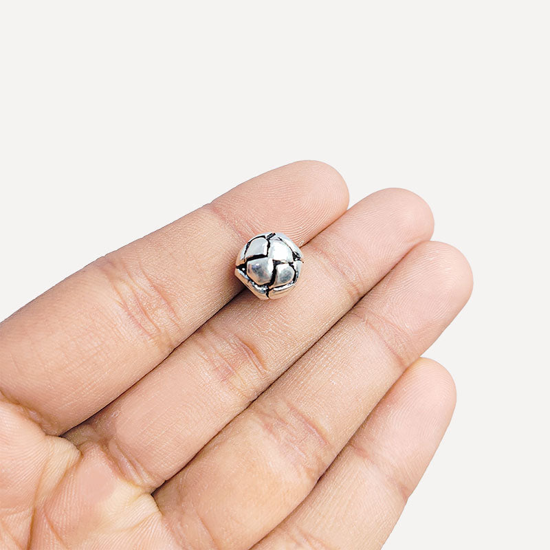 Geometric silver overlay over copper round bead handcrafted in India with hexagonal honeycomb texture