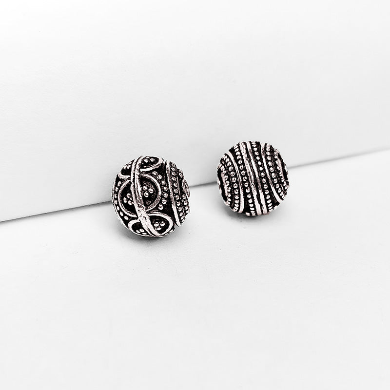 Textured silver overlay over copper round bead handcrafted in India with concentric dotted detailing