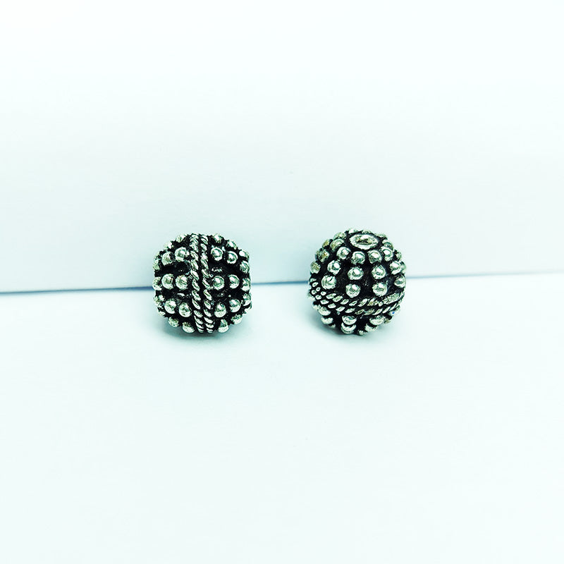 Detailed round granulated silver overlay over copper bead, handcrafted in India for boutique jewelry designs.