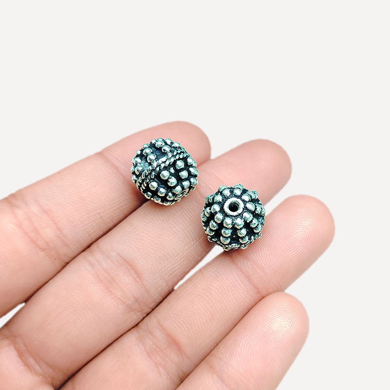 Detailed round granulated silver overlay over copper bead, handcrafted in India for boutique jewelry designs.