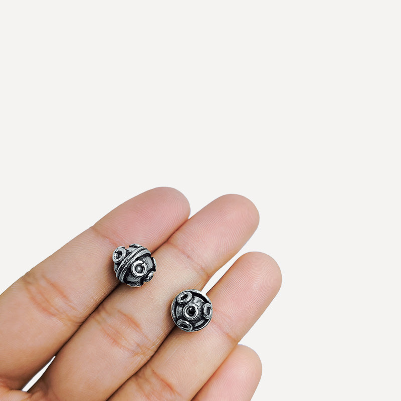 Handcrafted Silver Overlay Over Copper round beads from India with raised circular motifs and antique silver finish for DIY jewelry.