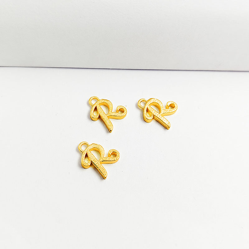 ‘R’ charm handcrafted in India featuring 18K Gold Overlay Over Copper with elegant textured finish.