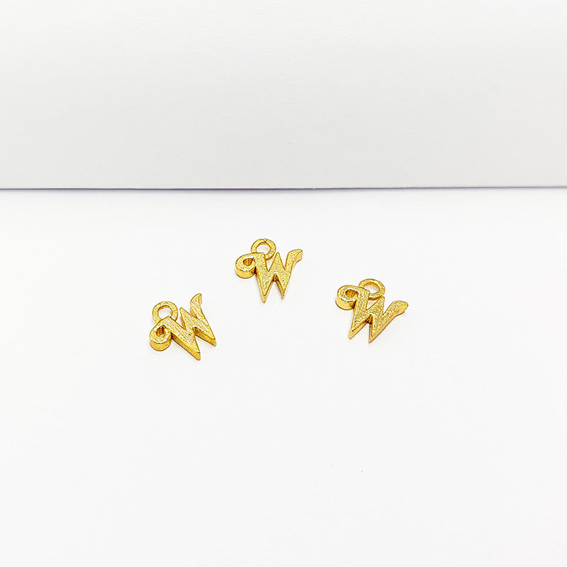 ‘W’ charm handcrafted in India featuring 18K Gold Overlay Over Copper with elegant textured finish.