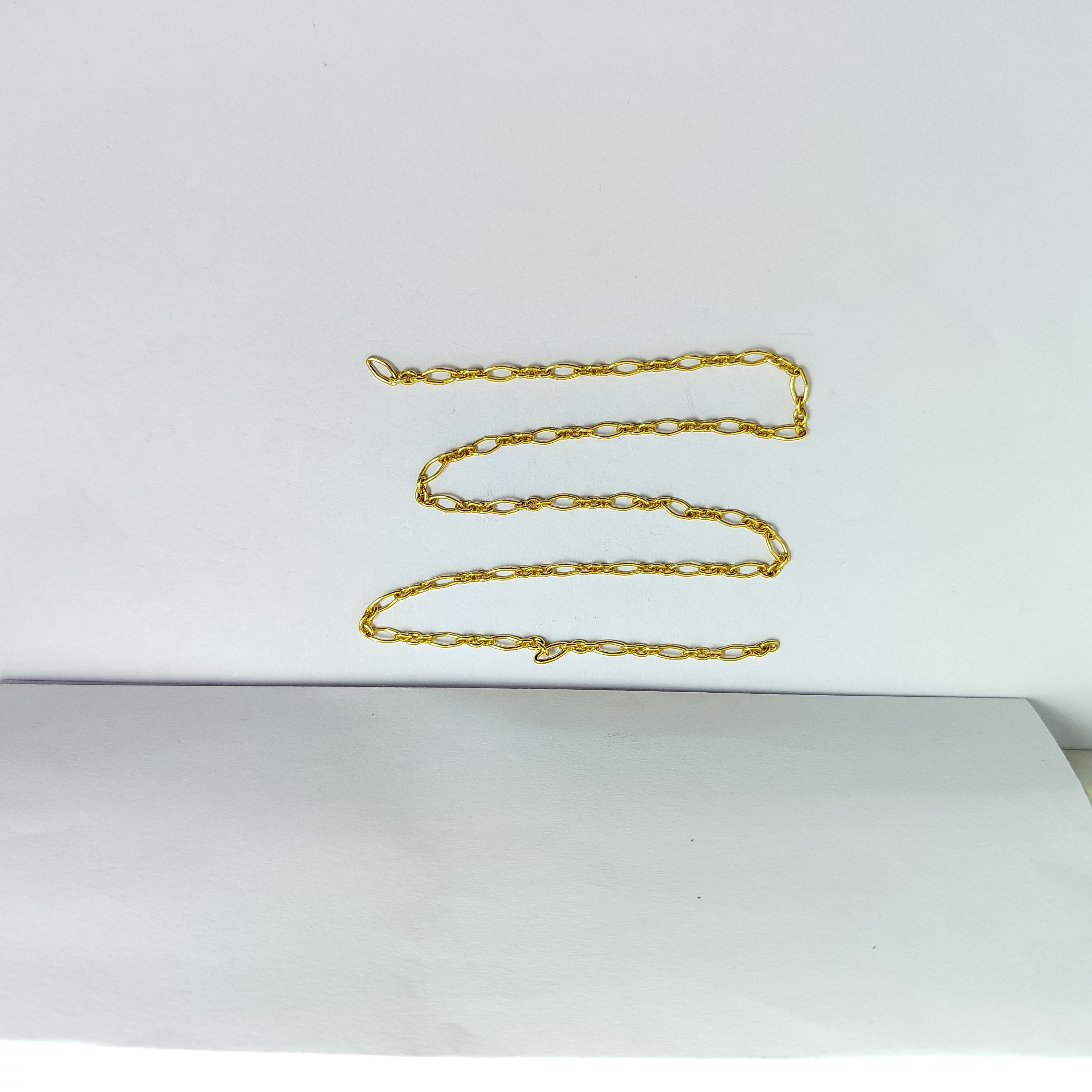 Alternating slim oval link jewelry chain crafted with 18K Gold Overlay Over Copper featuring mixed link sizes sold per foot