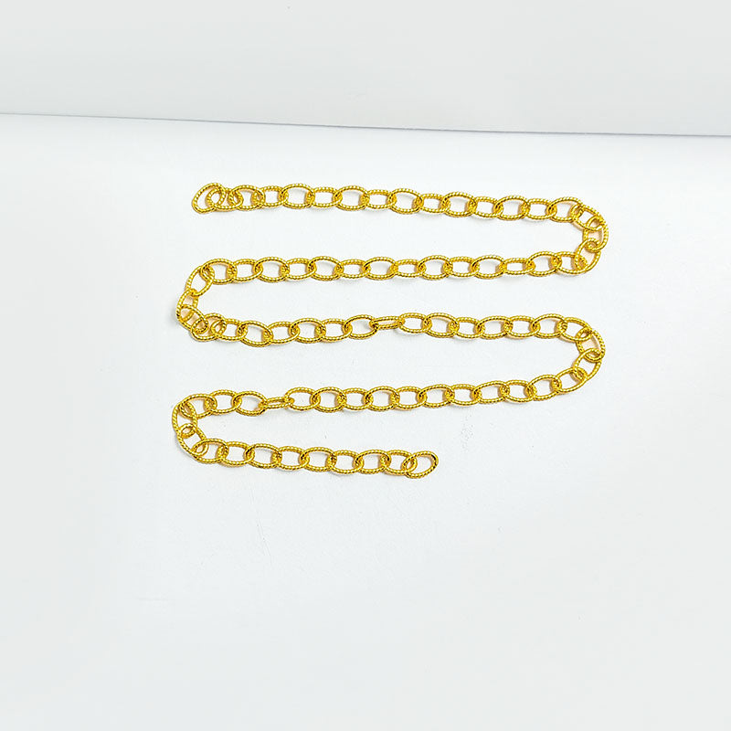 Textured oval link chain made with 18K Gold Overlay Over Copper featuring twisted detailing, smooth polished finish, and flexible length sold per foot for custom jewelry projects