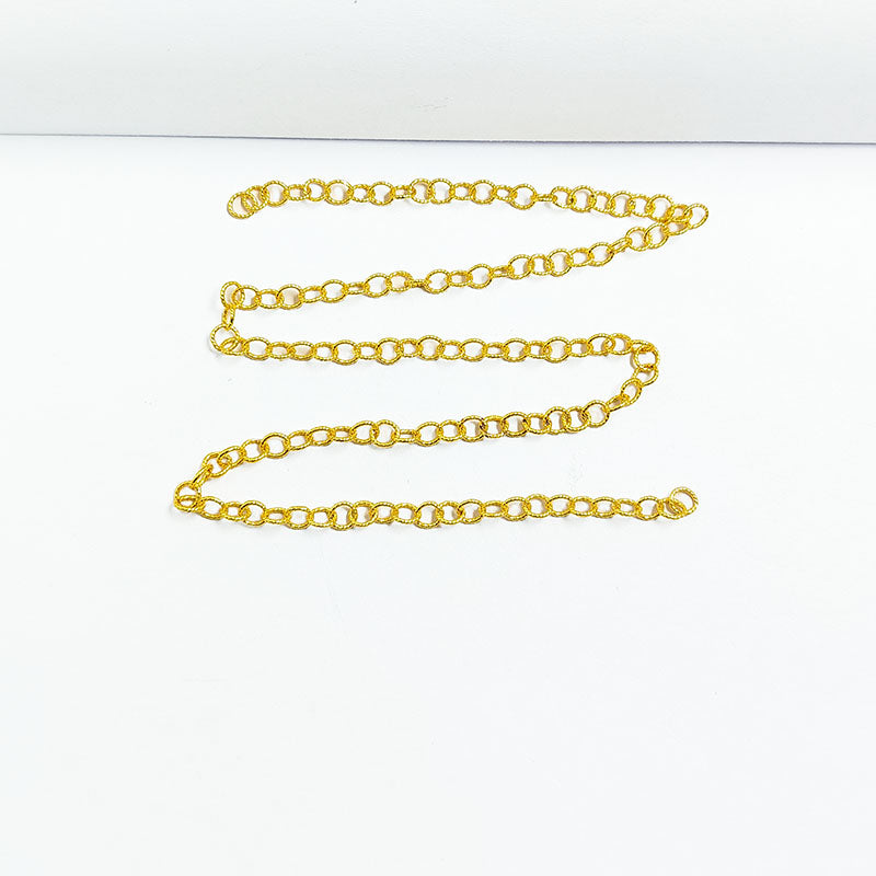 Textured oval link chain made with 18K Gold Overlay Over Copper featuring smooth polished 4MM links, twisted detailing, and flexible length sold per foot for custom jewelry projects