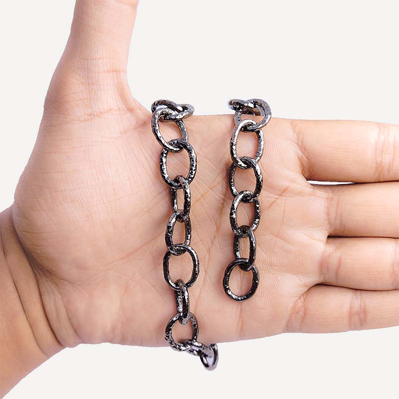 Oversized oval link chain made with Black Rhodium Overlay Over Copper featuring bold elongated textured links, polished dark finish, and flexible length sold per foot for statement jewelry styling