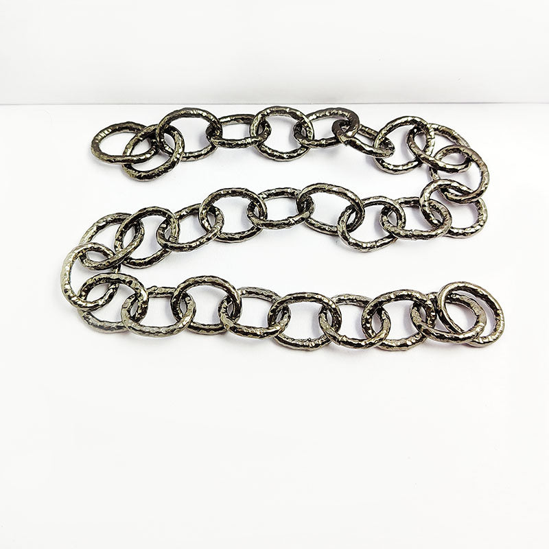 Oversized oval link chain made with Black Rhodium Overlay Over Copper featuring bold elongated textured links, polished dark finish, and flexible length sold per foot for statement jewelry styling