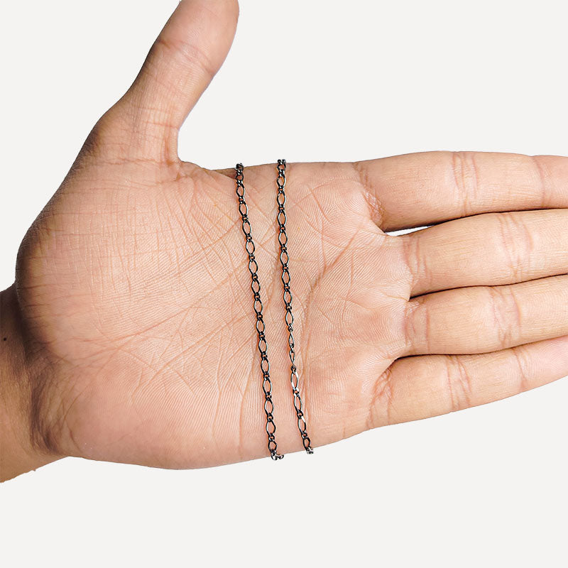 Elongated oval link chain crafted with Black Rhodium Overlay Over Copper, featuring smooth connectors and designed for custom jewelry layering and everyday styling