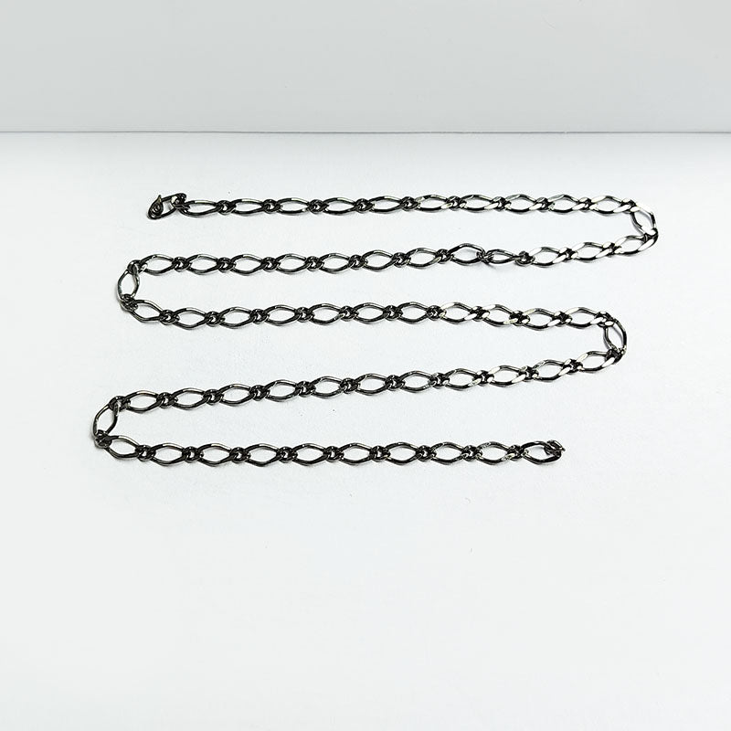 Elongated oval link chain crafted with Black Rhodium Overlay Over Copper, featuring smooth connectors and designed for custom jewelry layering and everyday styling