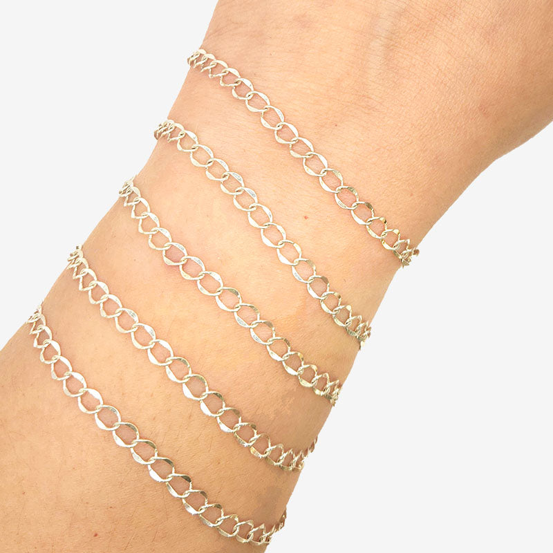 Silver overlay over copper oval link chain with polished finish and elegant smooth links displayed on white background for retail jewelry use