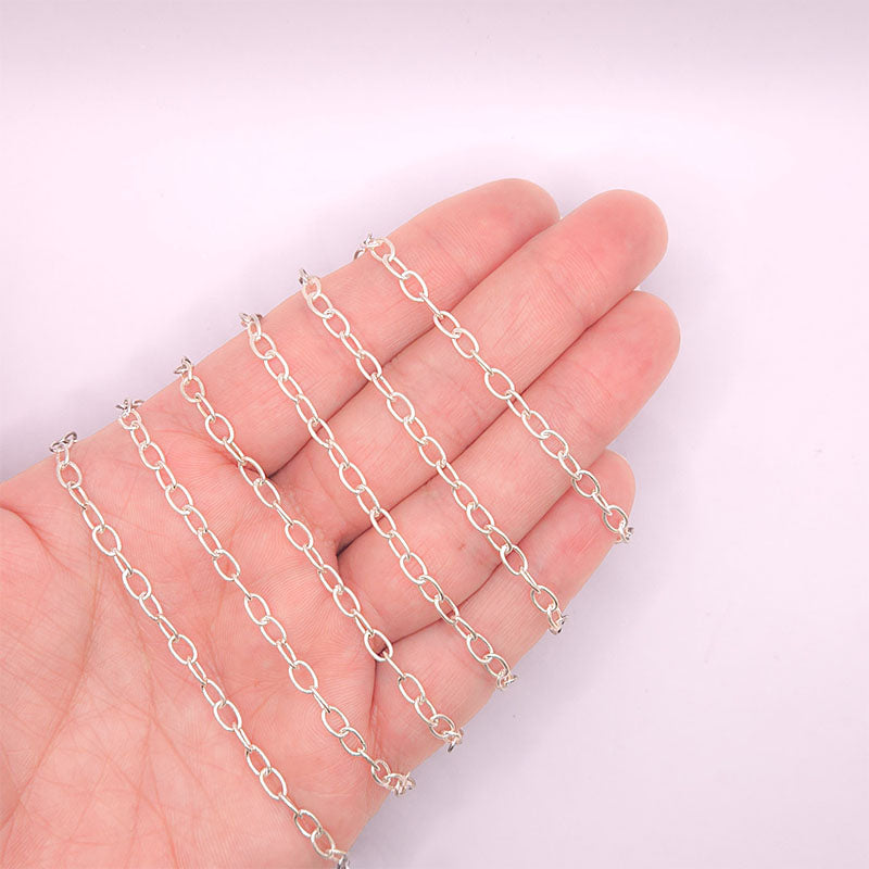 Silver overlay over copper oval link chain with polished finish and elegant smooth oval links displayed on white background for retail jewelry use