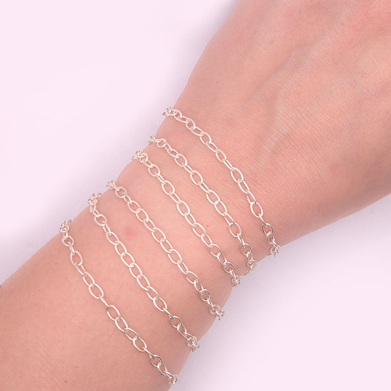 Silver overlay over copper oval link chain with polished finish and elegant smooth oval links displayed on white background for retail jewelry use