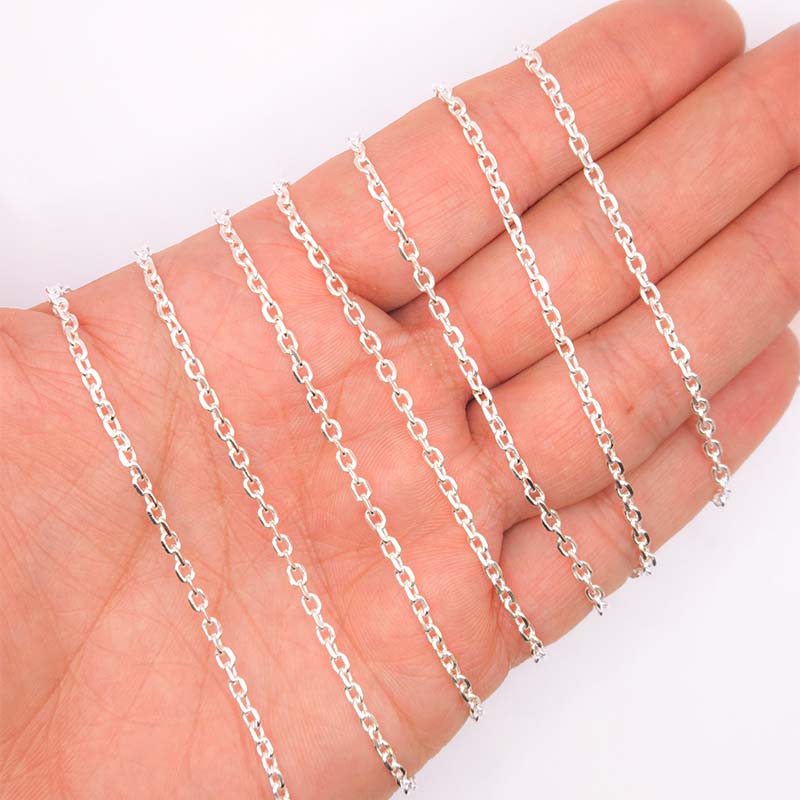 Silver overlay over copper fine oval link chain with polished finish and elegant compact oval links displayed on white background for retail jewelry use