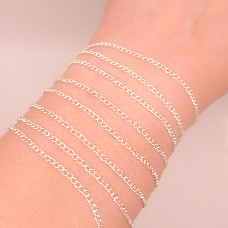 Silver overlay over copper beading and extender chain with polished oval links shown on white background for retail jewelry styling and customization