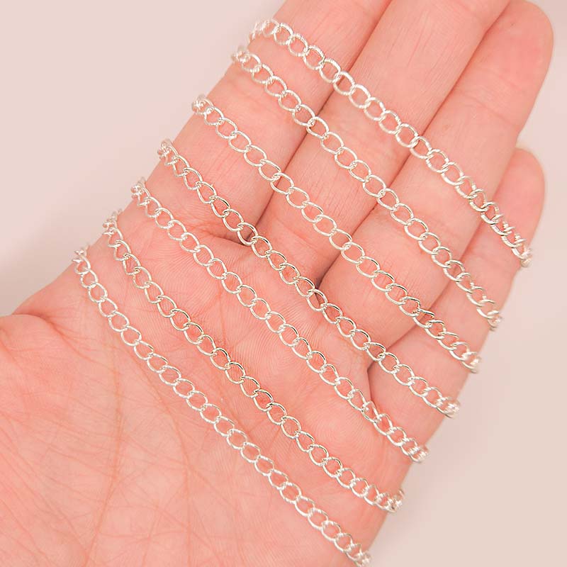 Silver overlay over copper beading and extender chain with polished oval links shown on white background for retail jewelry styling and customization