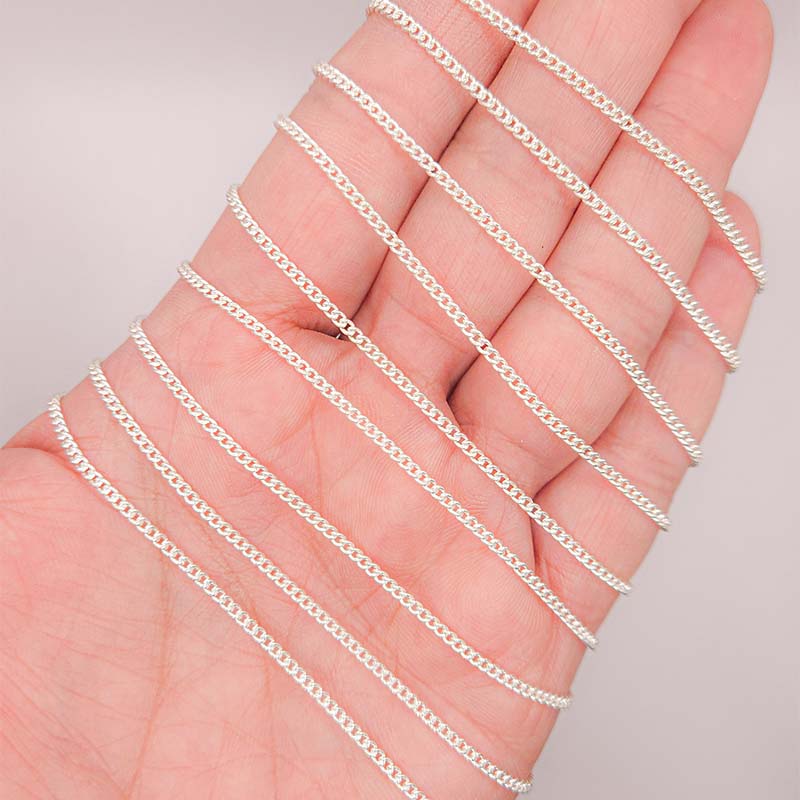 Silver overlay over copper beading and extender chain with polished curb links shown on white background for retail jewelry styling and customization