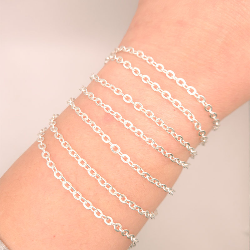 Silver overlay over copper beading and extender chain with polished oval links shown on white background for retail jewelry styling and customization