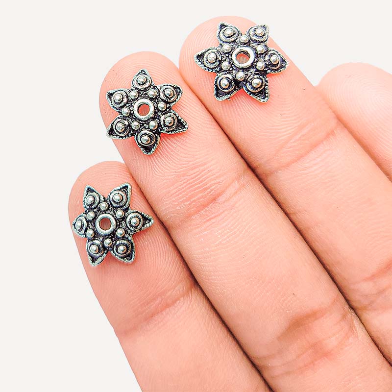 Silver overlay over copper bead cap from India handcrafted with floral design and oxidized silver finish