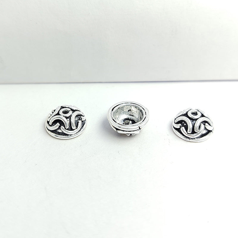 Silver overlay over copper bead cap from India with handcrafted swirl pattern and oxidized silver finish