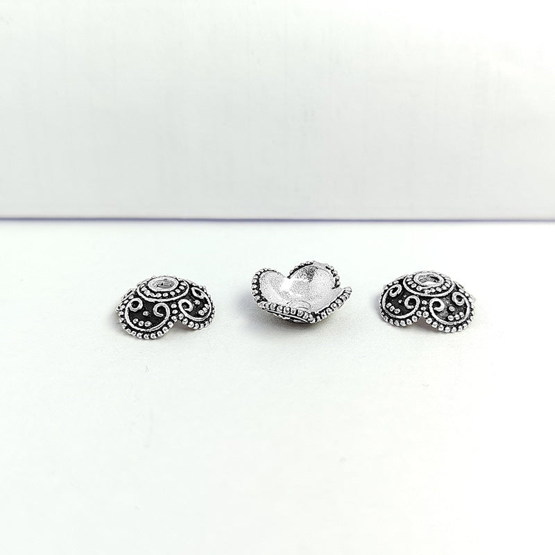 Silver overlay over copper bead cap from India with handcrafted scroll and dotted pattern in oxidized silver finish