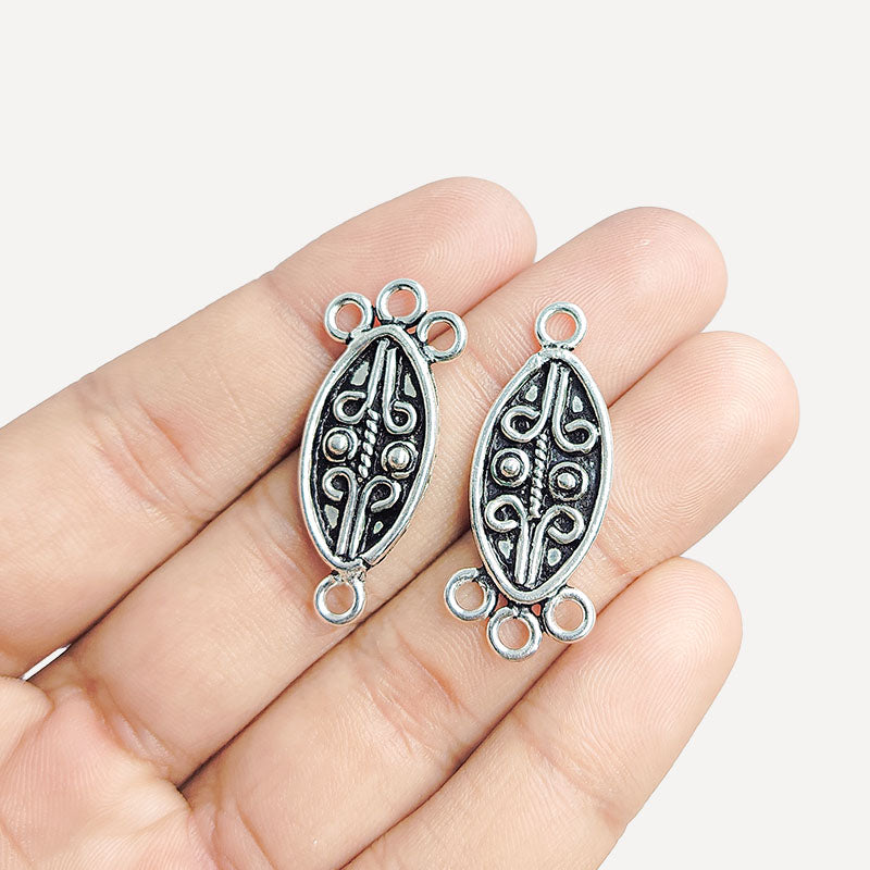 Silver Overlay Over Copper India oval 3 hole pendant connector with oxidized scroll detailing.