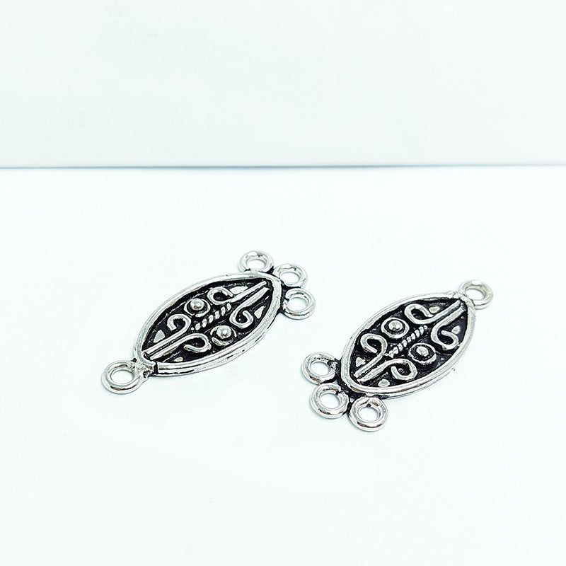Silver Overlay Over Copper India oval 3 hole pendant connector with oxidized scroll detailing.