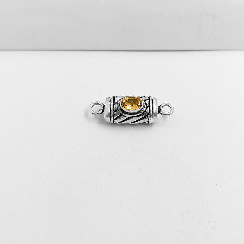 Polished silver overlay connector pendant with oval yellow stone crafted from silver overlay over copper in India.