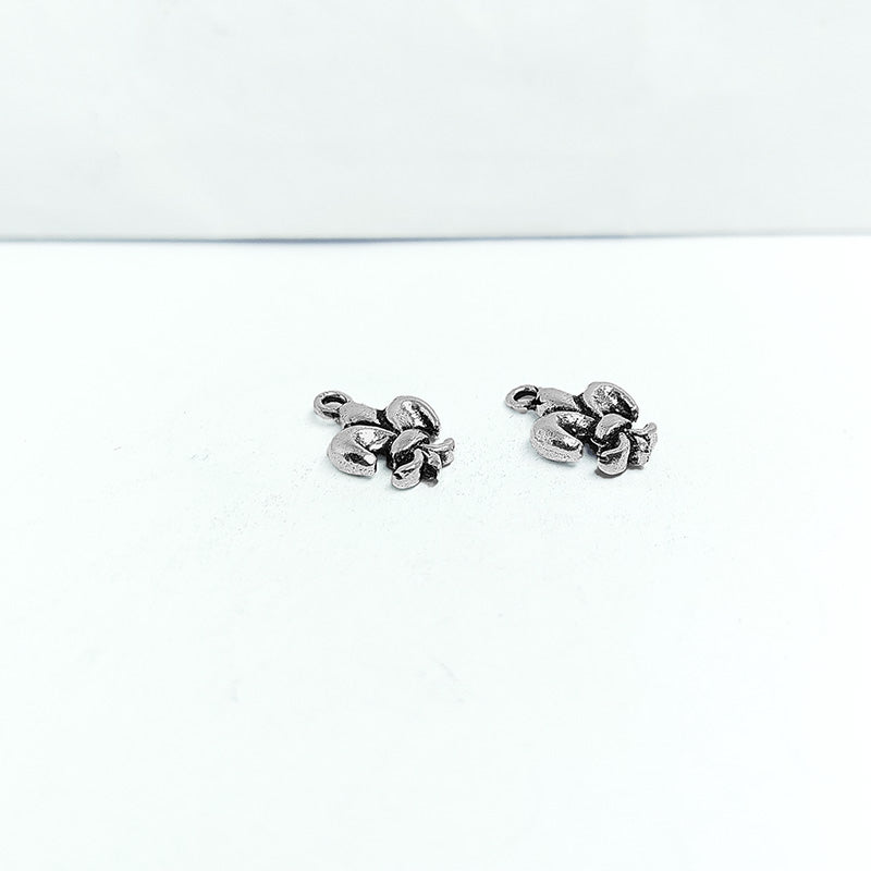 Handcrafted silver overlay over copper fleur-de-lis charm pendant from India with vintage-style detailing