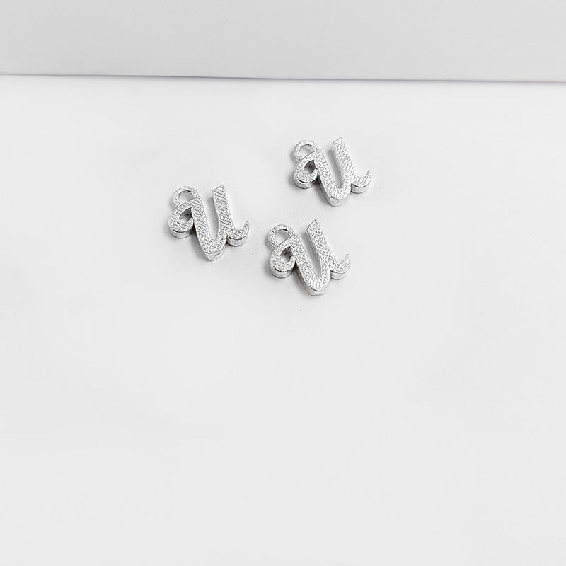 Handcrafted Silver Overlay Over Copper alphabet “U” charm from India with polished textured silver finish for handmade jewelry.