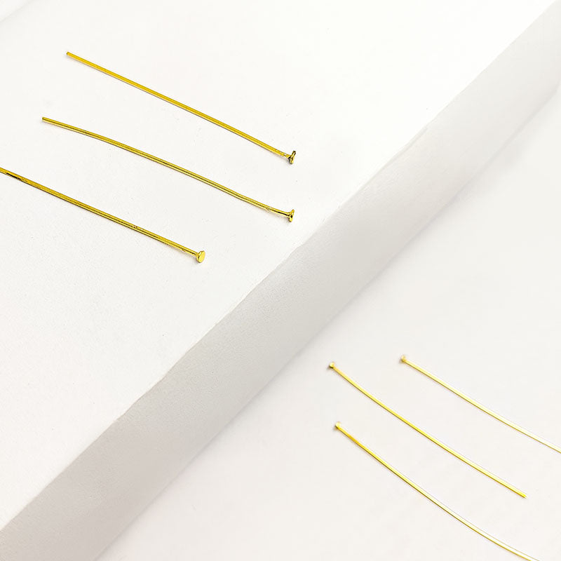 Polished flat-head gold-overlay copper pin handcrafted in India.