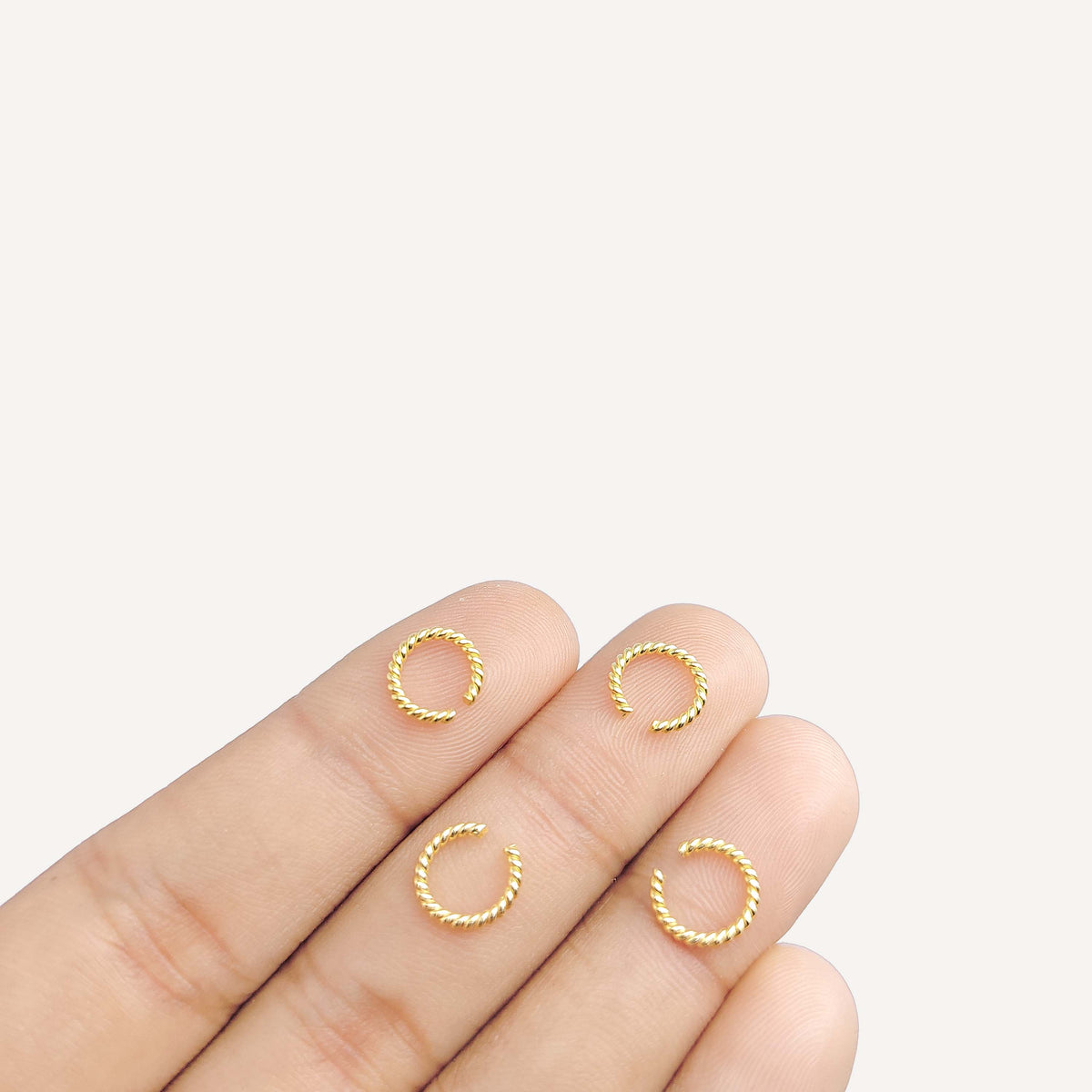 Elegant twisted jump ring in 18K gold overlay over copper, polished finish, handcrafted in India.