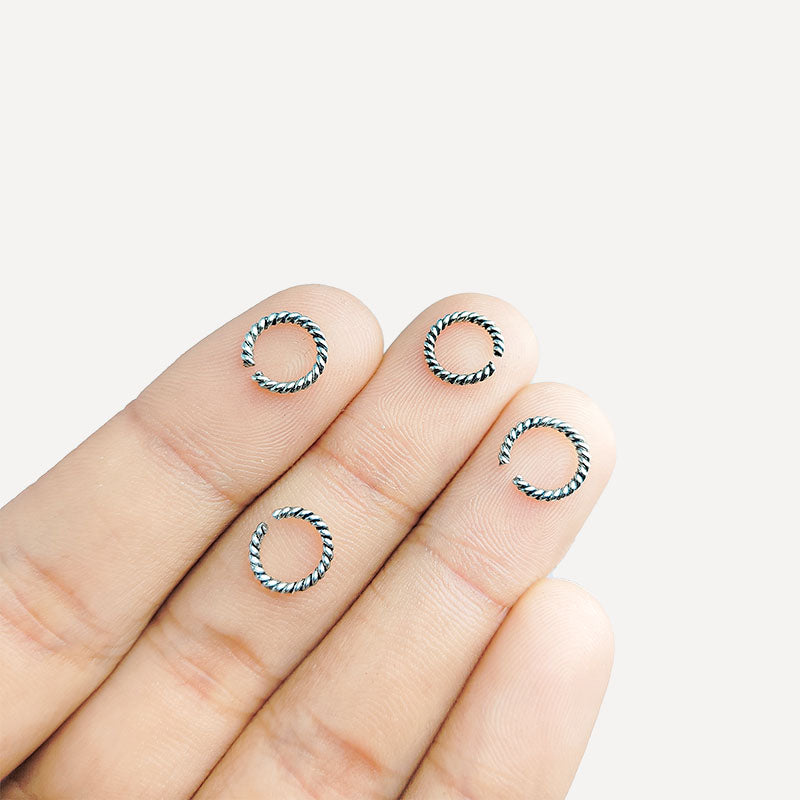 Luxury silver overlay twisted open jump ring with polished finish, handcrafted in India for elegant jewelry making.