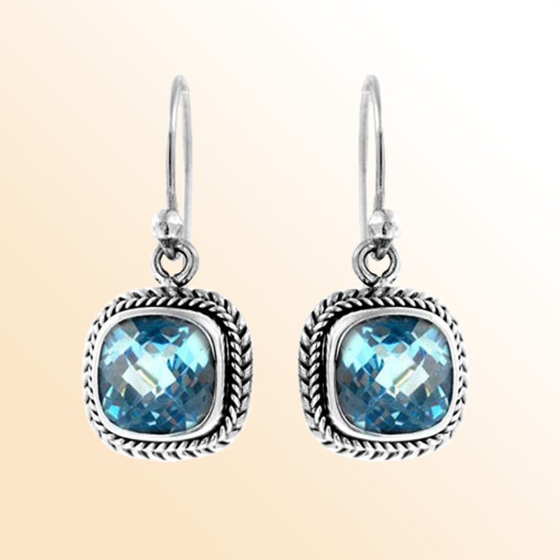 Handcrafted sterling silver dangle earrings with cushion cut blue topaz quartz and rope detailing made in Bali.