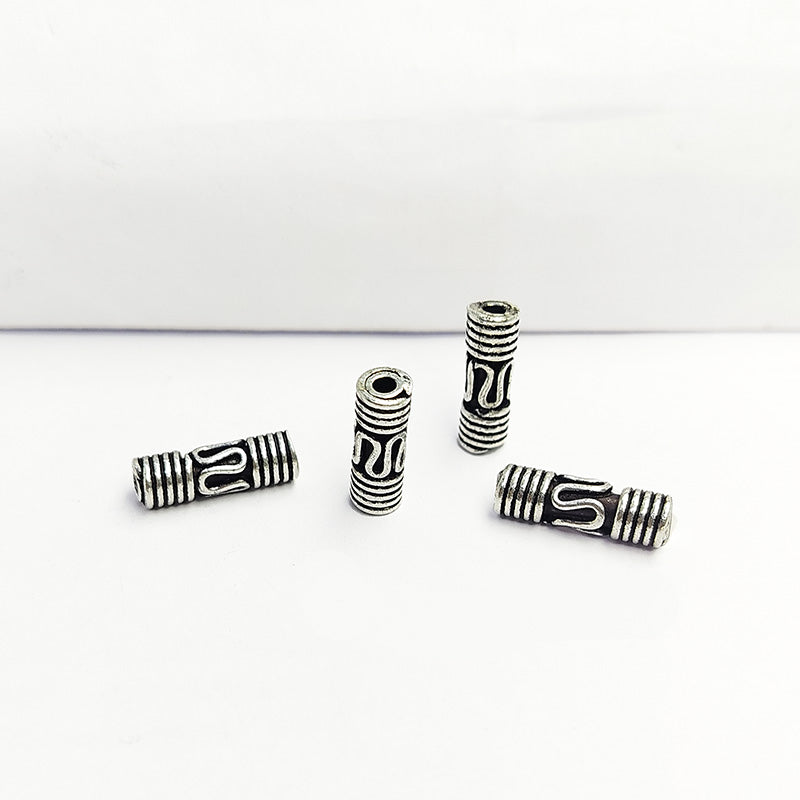 Cylindrical silver overlay tube bead over copper with engraved details and oxidized finish handcrafted in India for jewelry making