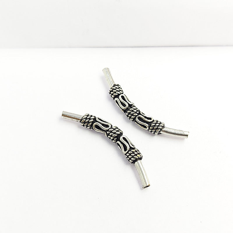 Handcrafted silver overlay over copper tube Bali charm from India with oxidized detailing and curved tube design
