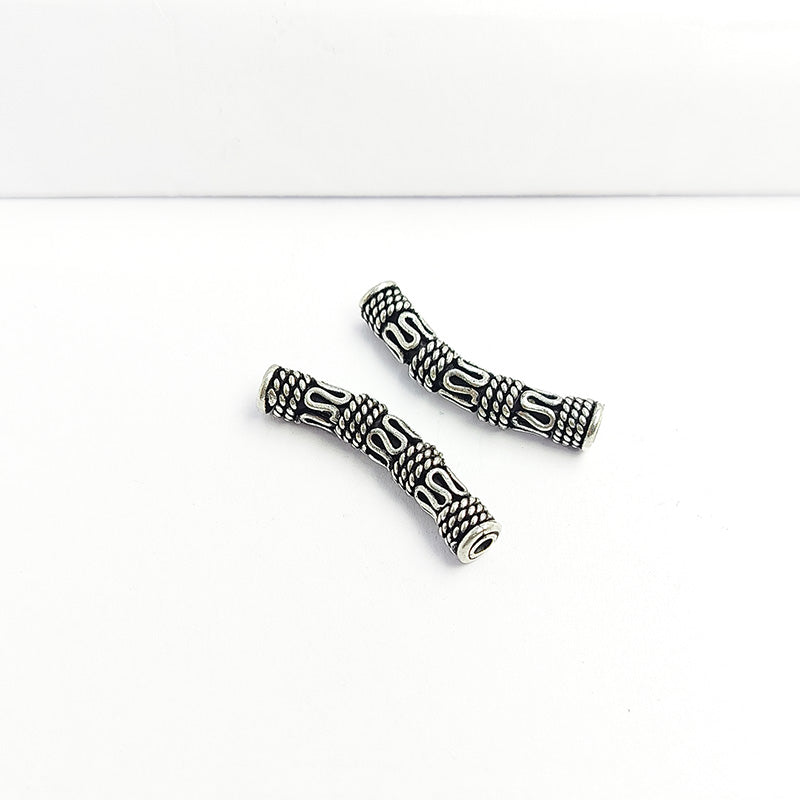 Handcrafted silver overlay over copper tube Bali curved charm from India with oxidized detailing and artisan design