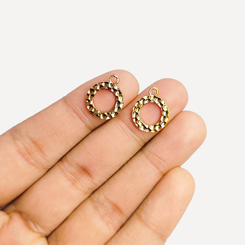 Handcrafted rose gold overlay over copper round charm from India with textured finish for elegant jewelry designs.