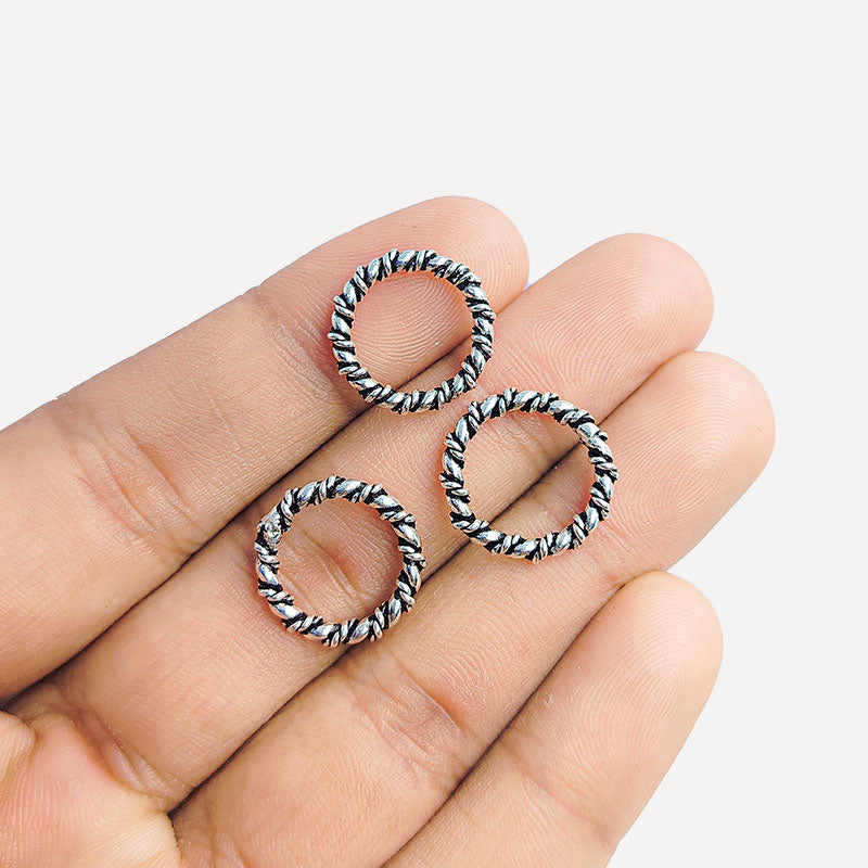 Artisan twisted link silver overlay over copper band ring with textured finish handcrafted in India